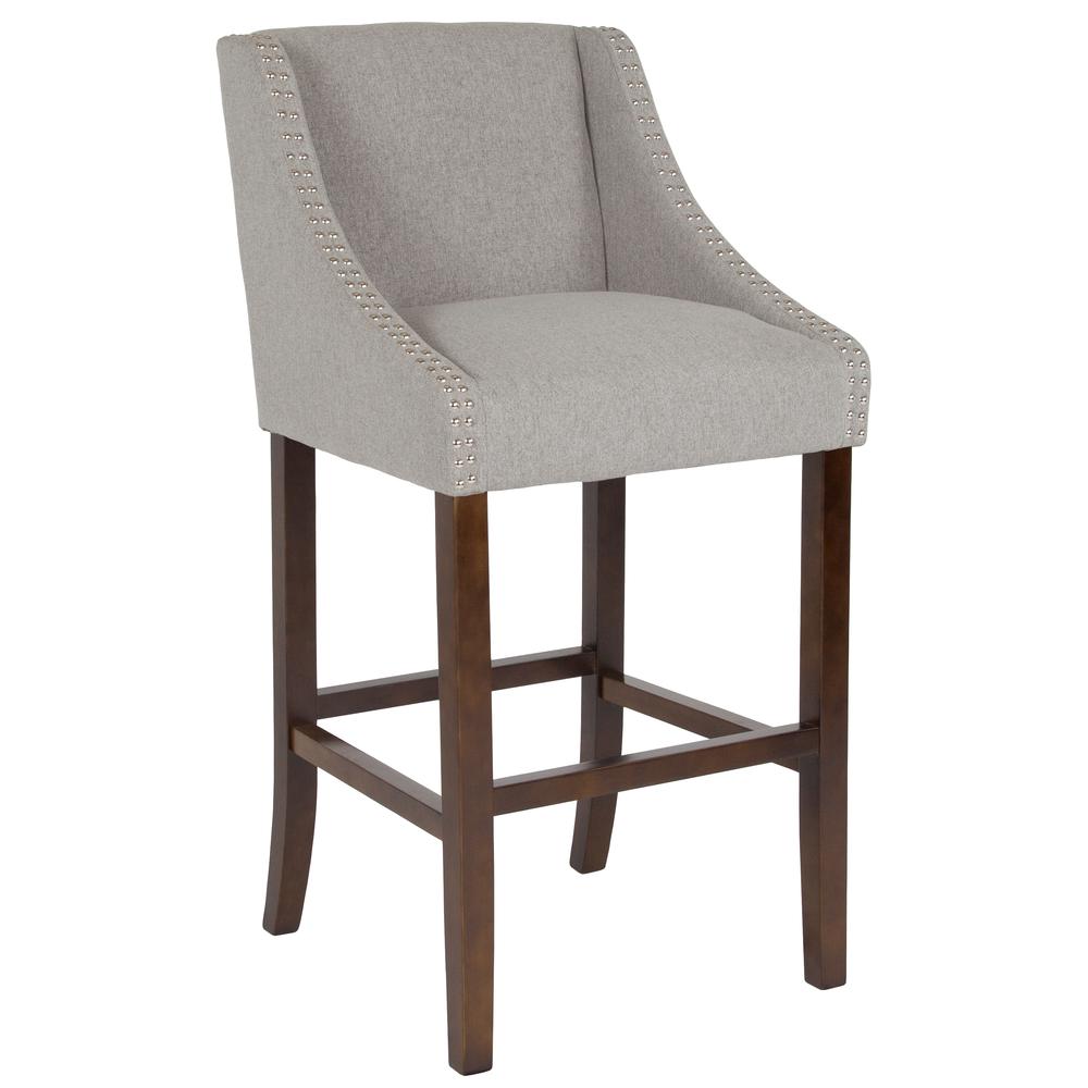 Carmel Series 30" High Transitional Walnut Barstool with Accent Nail Trim in Light Gray Fabric. The main picture.