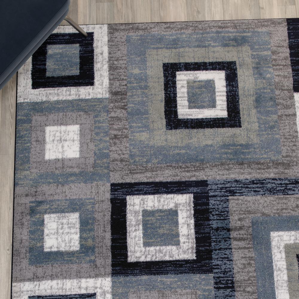 Geometric 5' x 7' Blue, Grey, and White Olefin Area Rug with Cotton Backing. Picture 7