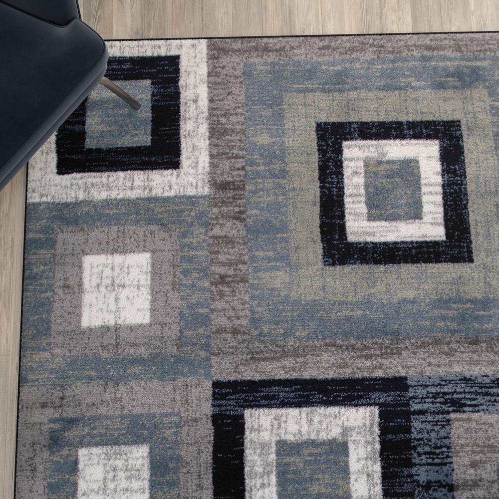 Geometric 6' x 9' Blue, Grey, and White Olefin Area Rug with Cotton Backing. Picture 7