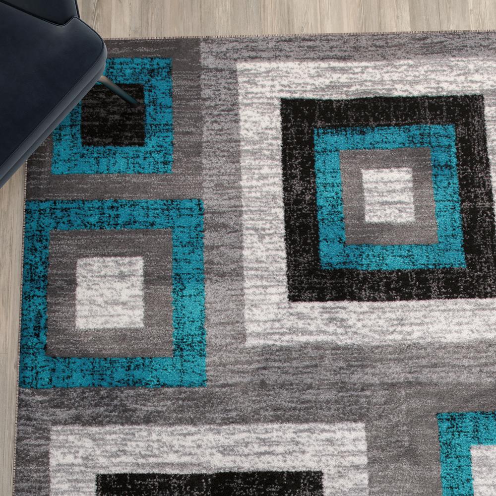 Geometric 6' x 9' Turquoise, Grey, and White Olefin Area Rug with Cotton Backing. Picture 7