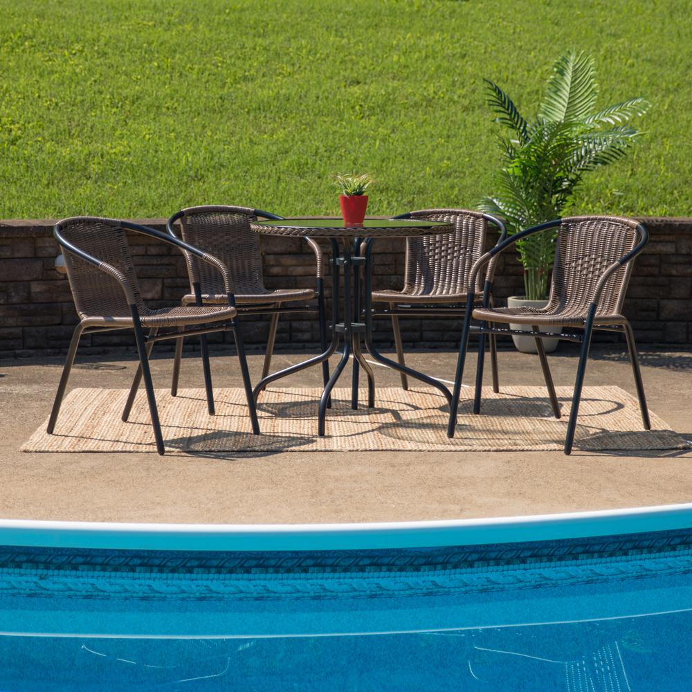 28'' Round Glass Metal Table with Dark Brown Rattan Edging and 4 Dark Brown Rattan Stack Chairs. Picture 4