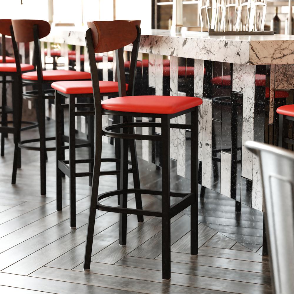 Wright Commercial Barstool with 500 LB. Capacity Black Steel Frame, Walnut Finish Wooden Boomerang Back, and Red Vinyl Seat. The main picture.