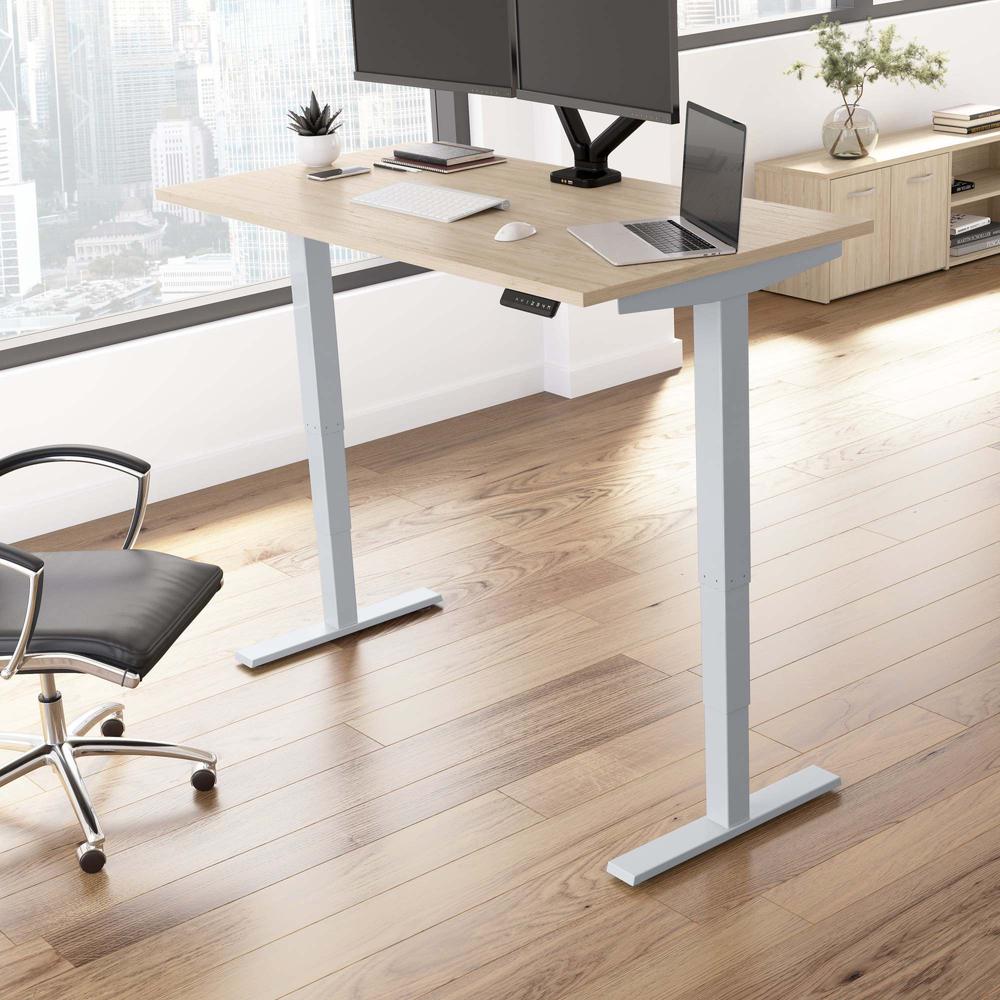 Electric Height Adjustable Standing Desk in Natural Elm with Silver Base. Picture 3