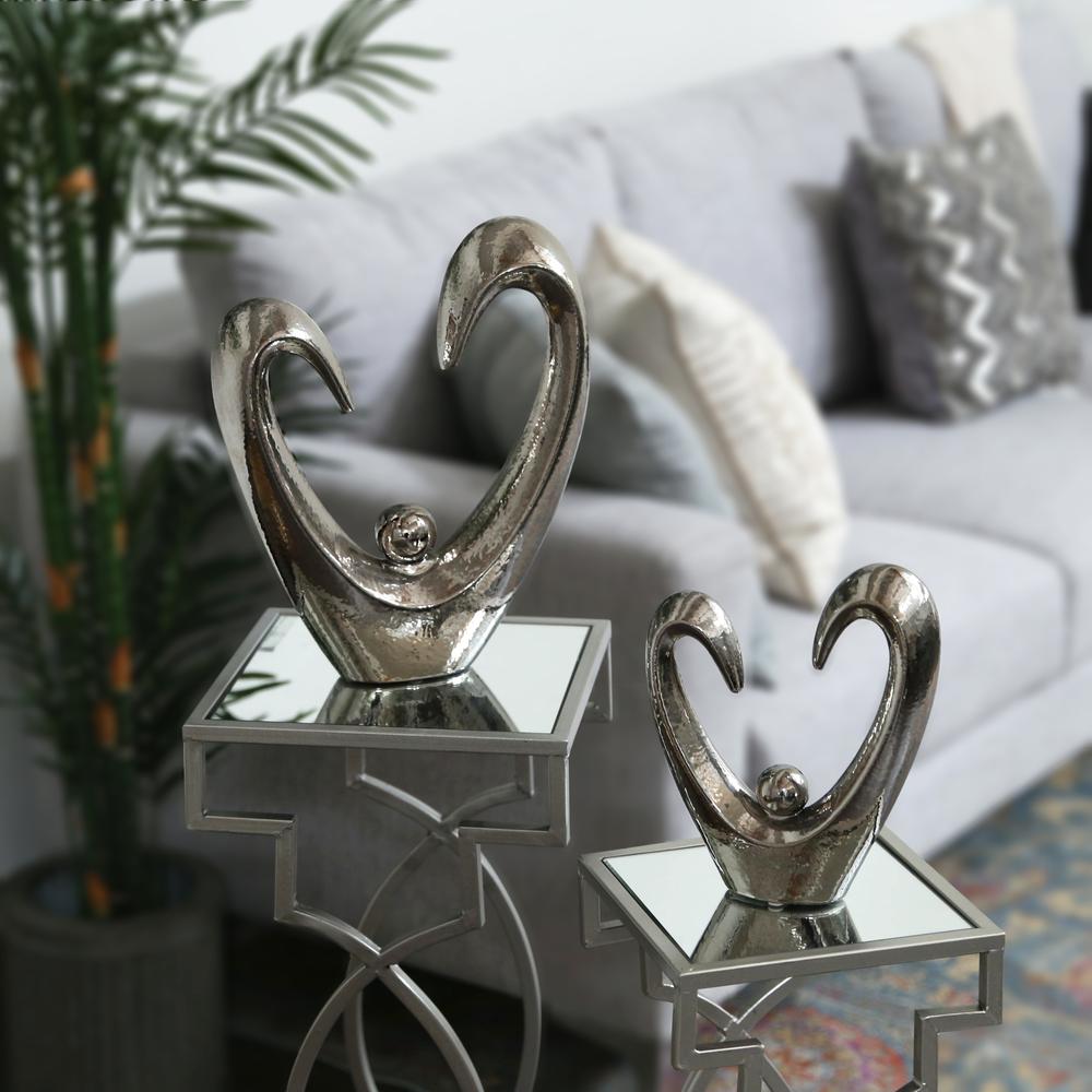 Ceramic Open Heart  Abstract Sculpture on Base with Round Figurine in Center LG Polished Chrome Finish Silver. The main picture.