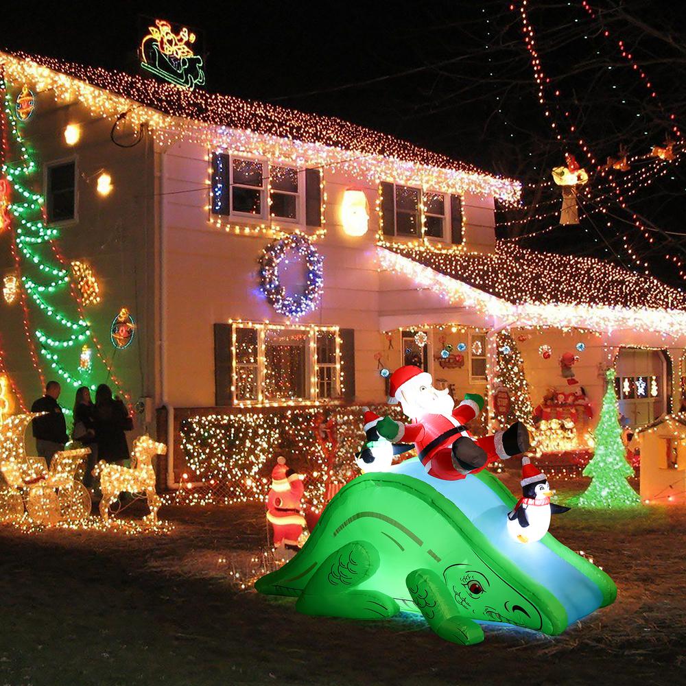 Santa and Penguins Trio Sliding on a Dinosaur Inflatable Holiday Decoration. Picture 4