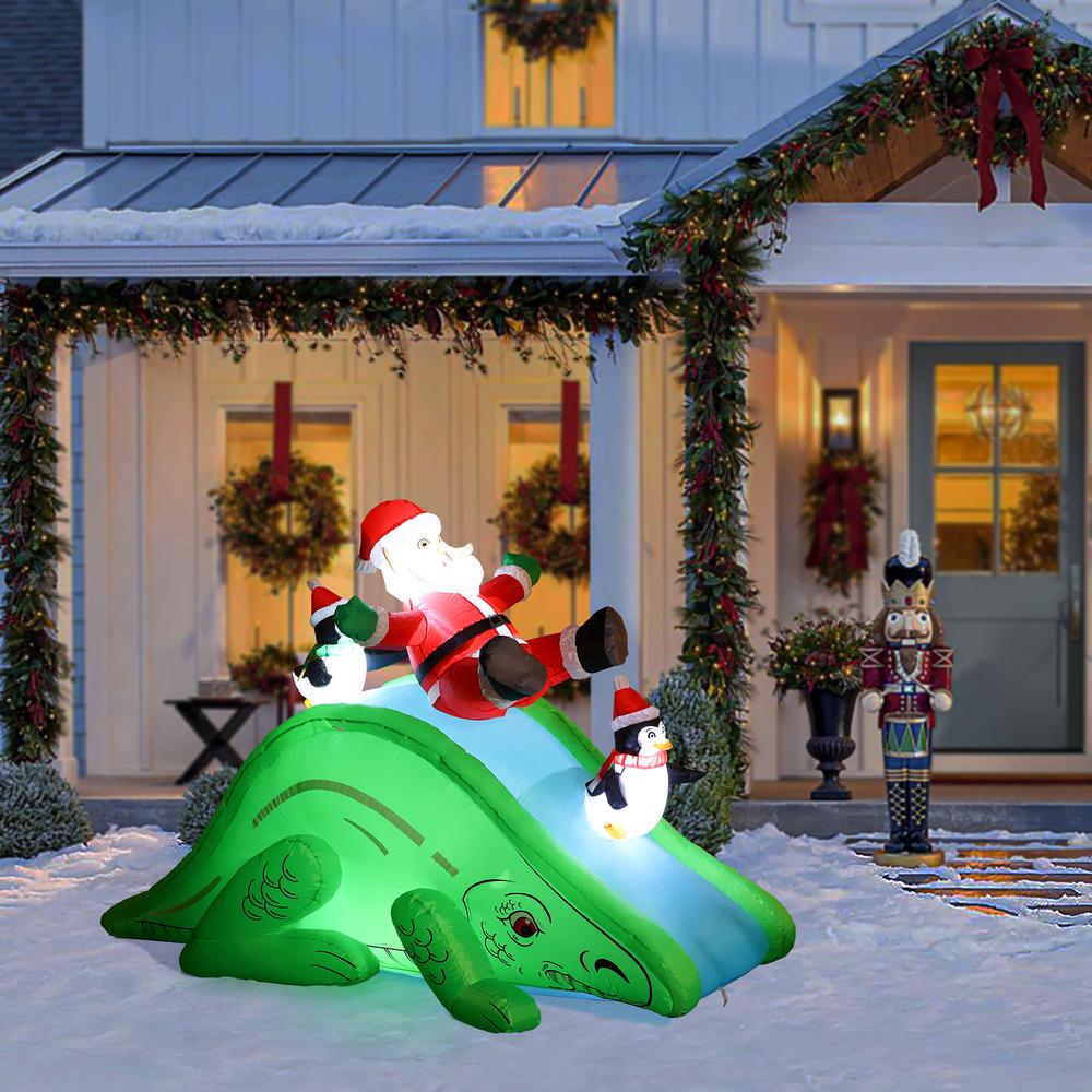 Santa and Penguins Trio Sliding on a Dinosaur Inflatable Holiday Decoration. Picture 2