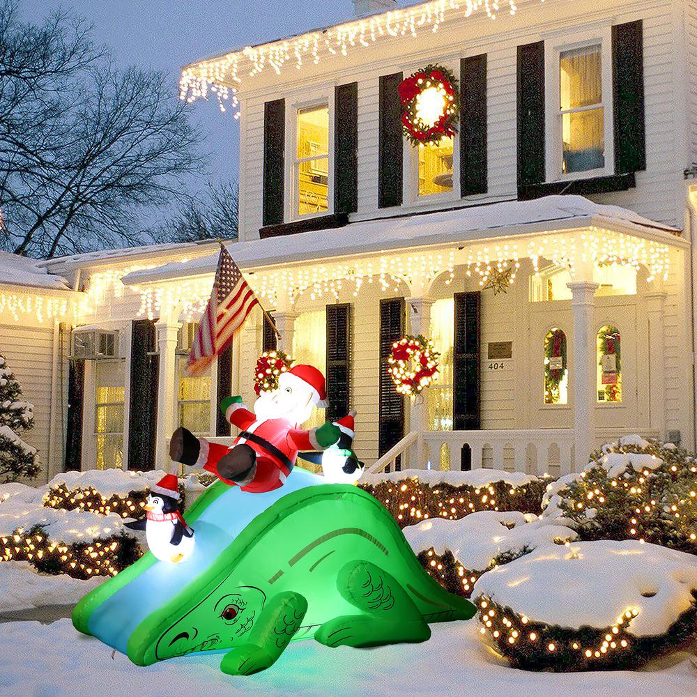 Santa and Penguins Trio Sliding on a Dinosaur Inflatable Holiday Decoration. Picture 3