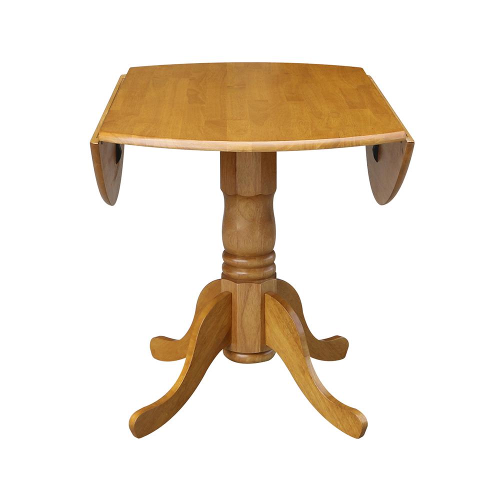 42" Round Dual Drop Leaf Pedestal Table, Oak. Picture 7
