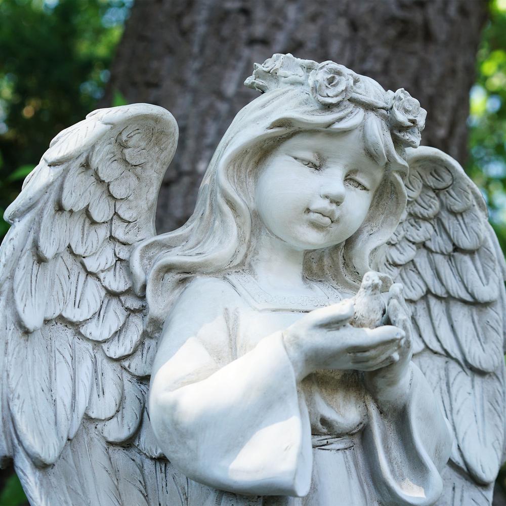 20.5" White Standing Angel Holding a Bird Outdoor Garden Statue. Picture 3