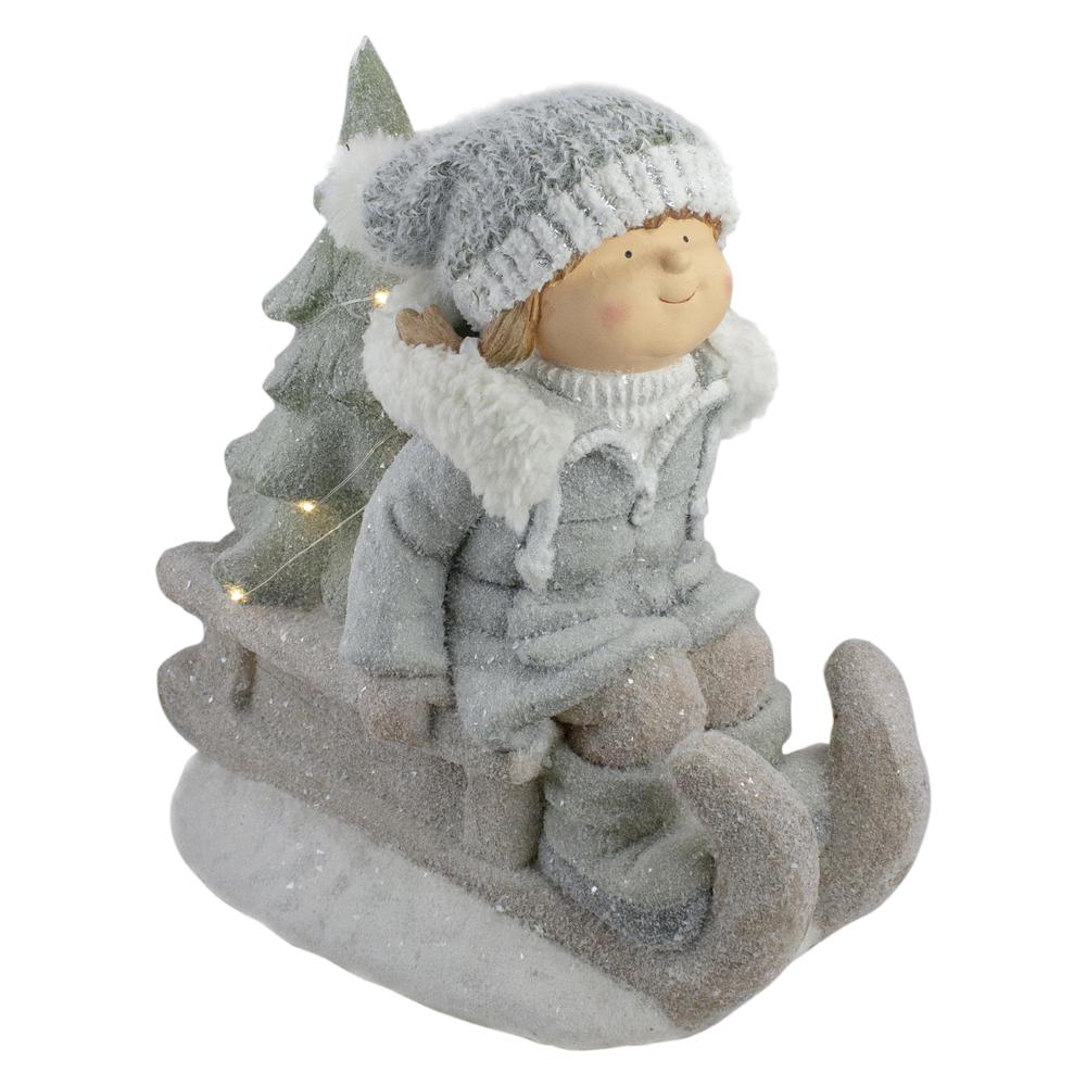 15" Beige and Green Lighted Girl on a Sled Christmas Decoration. The main picture.