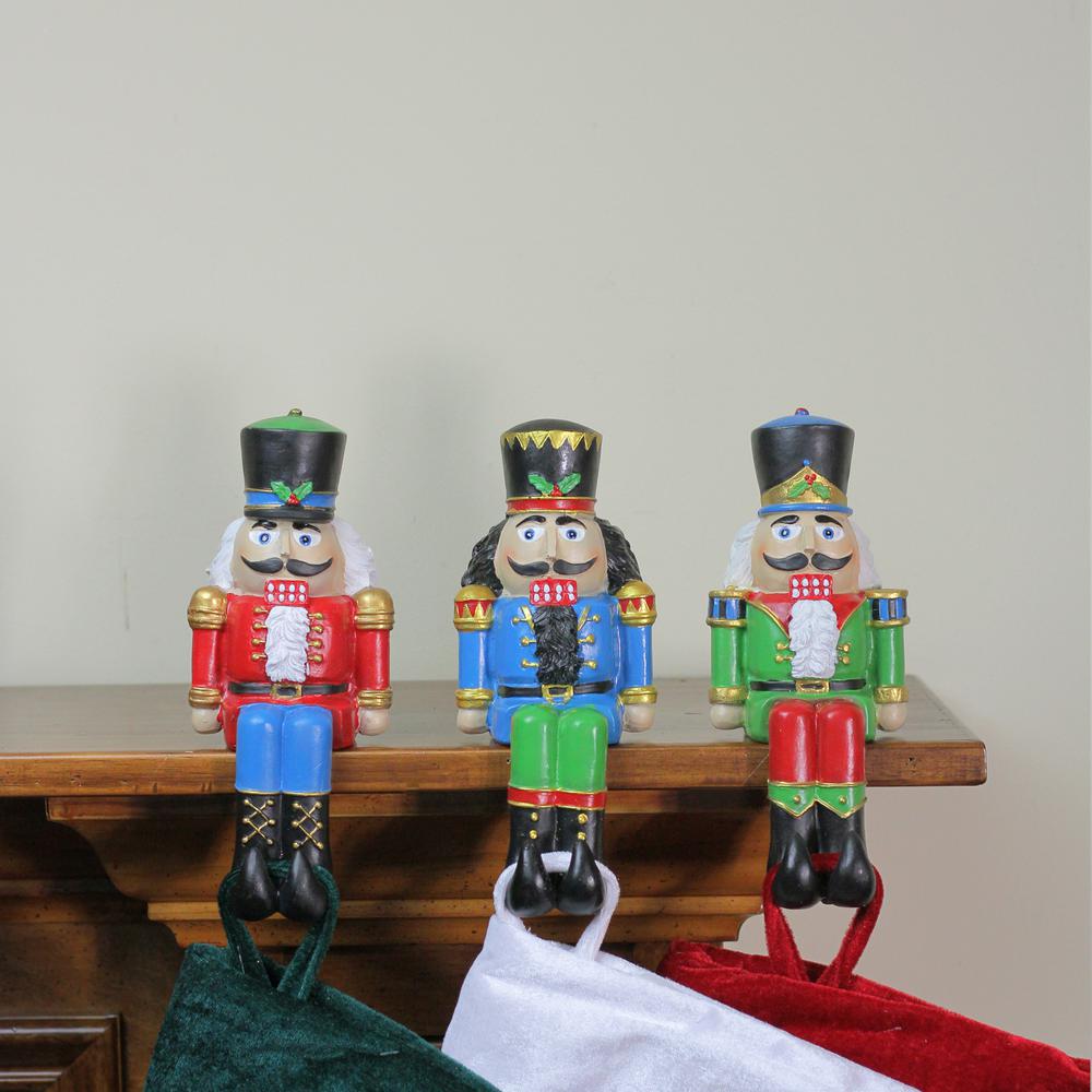Set of 3 Red  Blue and Green Nutcracker Christmas Stocking Holders 7.5". Picture 3