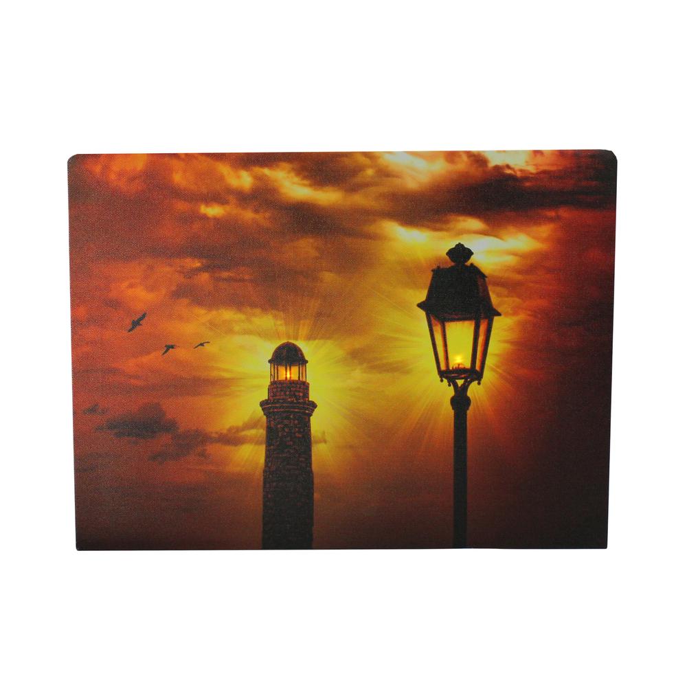 LED Lighted Lighthouse and Lantern Lamp Post with Amber Sky Canvas Wall Art 15.75" x 11.75". Picture 1