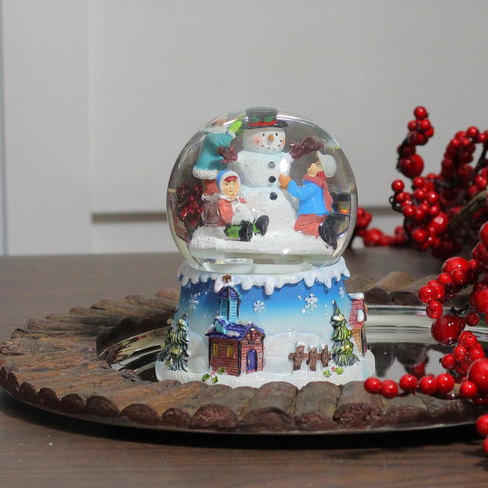 5.75" Children Building Snowman Musical Christmas Snow Globe. Picture 3