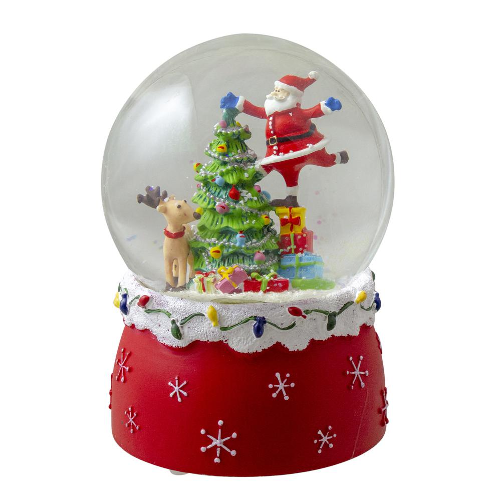 5.75" Santa Decorating a Christmas Tree Musical Snow Globe. Picture 1