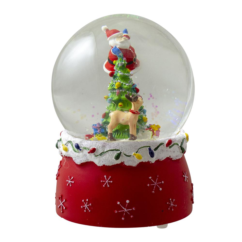 5.75" Santa Decorating a Christmas Tree Musical Snow Globe. Picture 4