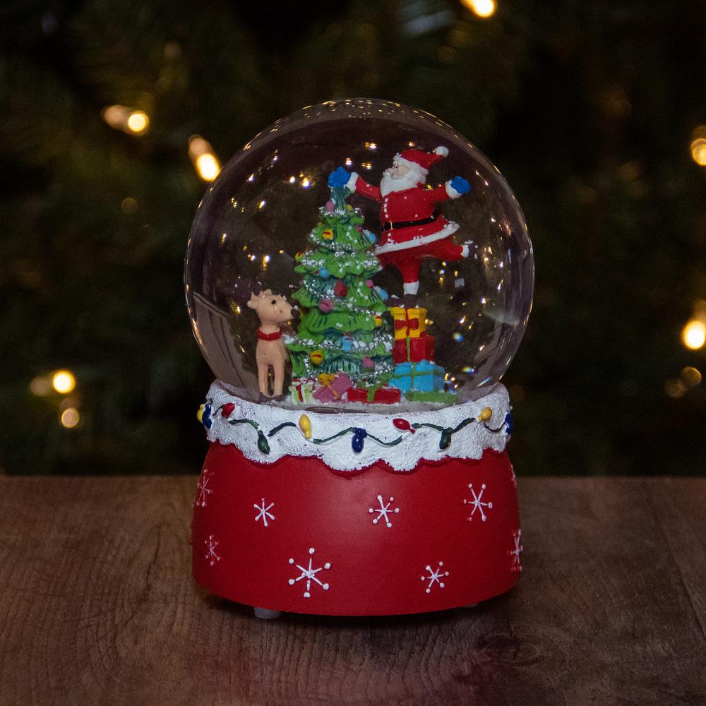 5.75" Santa Decorating a Christmas Tree Musical Snow Globe. Picture 2