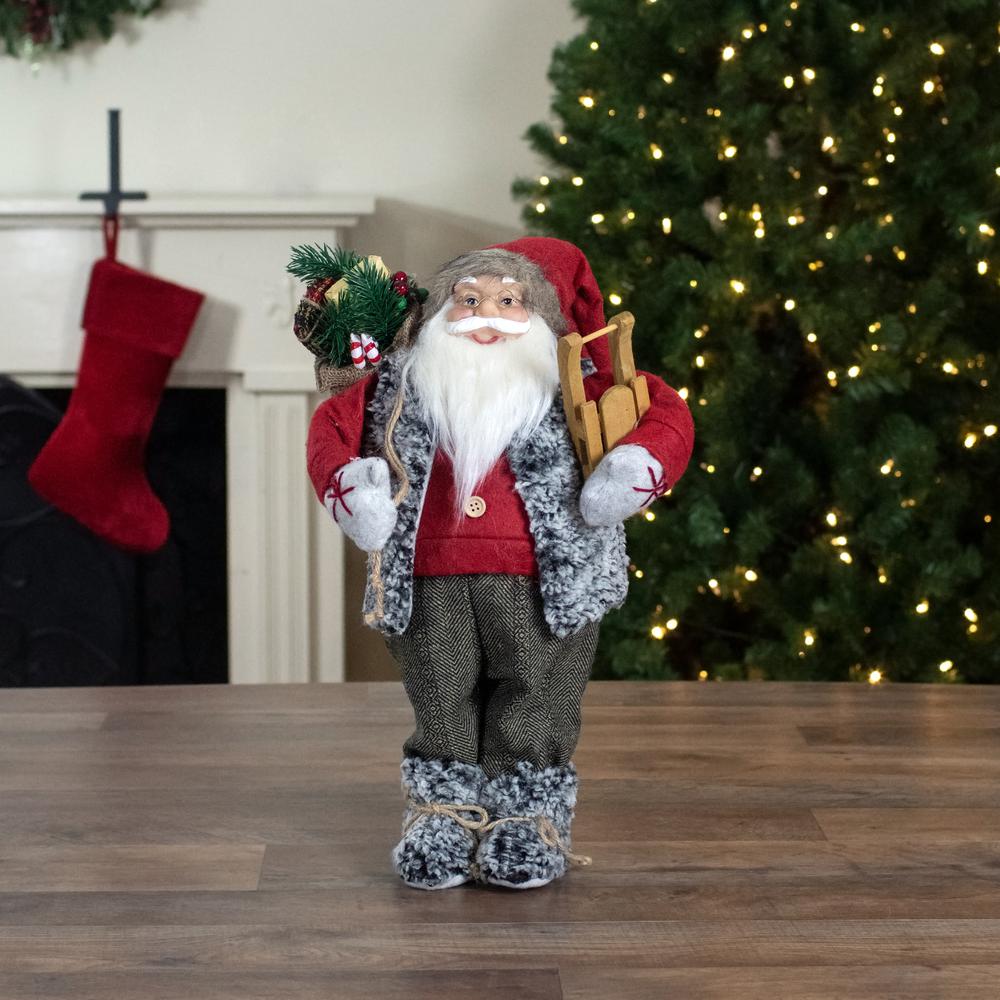 18" Standing Santa Christmas Figure Carrying Presents and a Sled. Picture 2