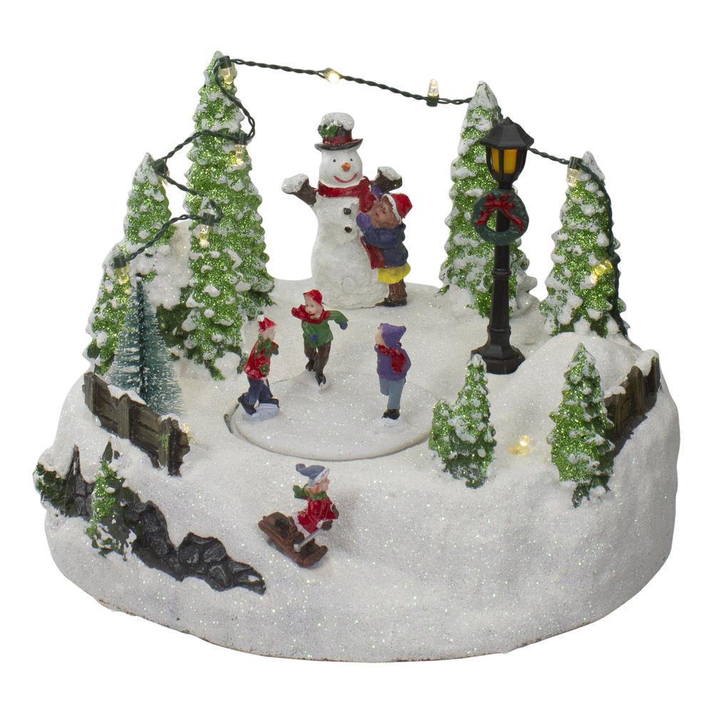 9" Lighted Christmas Scene with Moving Skaters and a Snowman. Picture 1