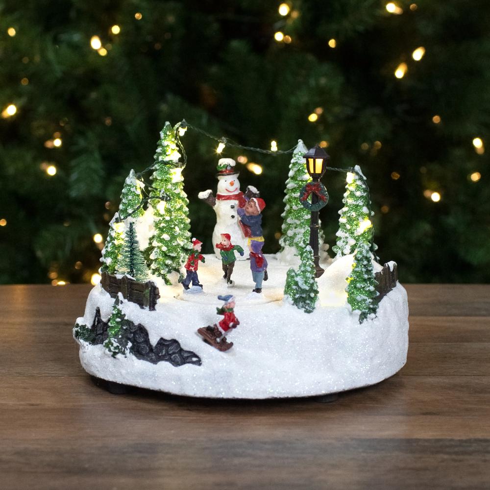 9" Lighted Christmas Scene with Moving Skaters and a Snowman. Picture 2