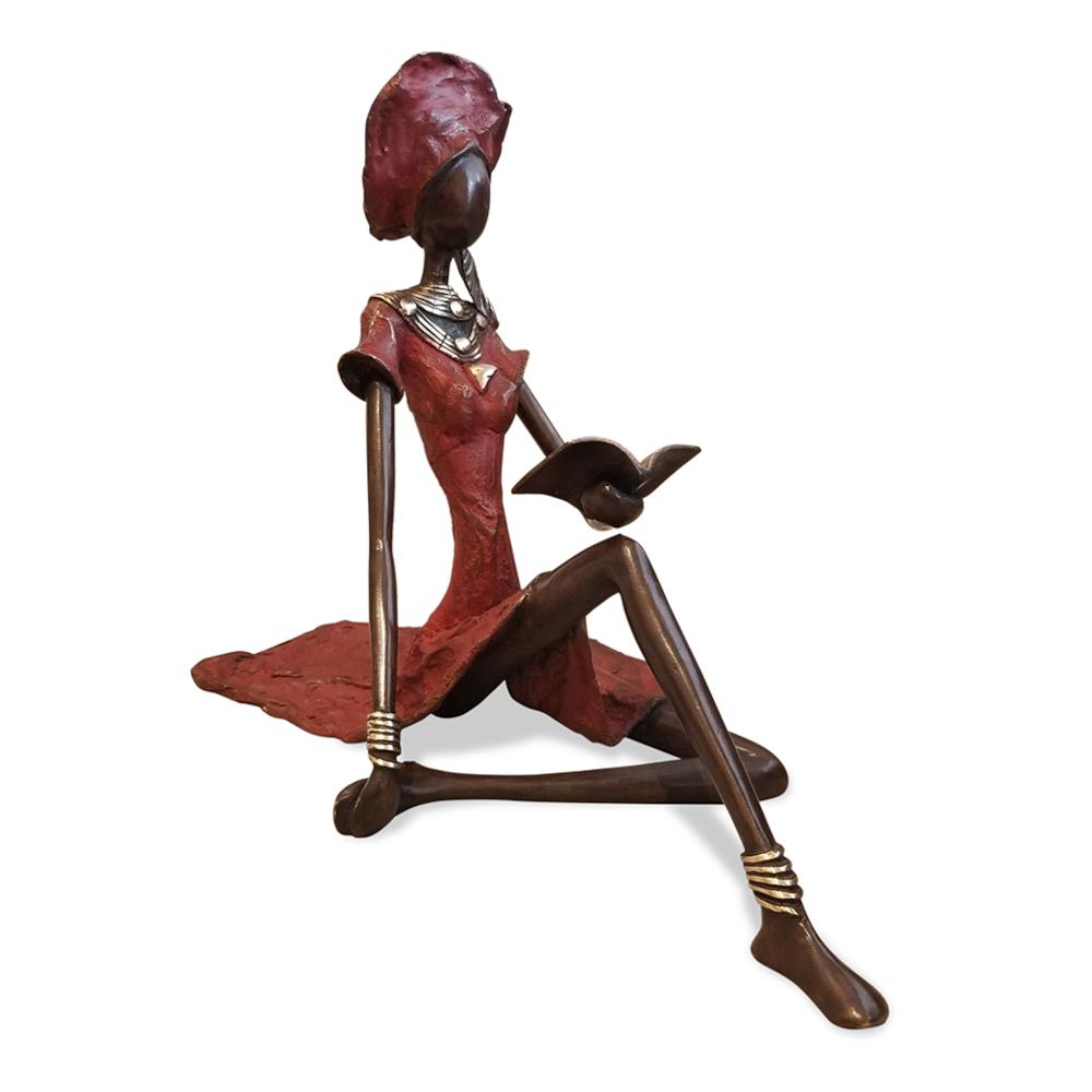 Vintage Bronze Seated West African Woman Reading Sculpture Red. Picture 1