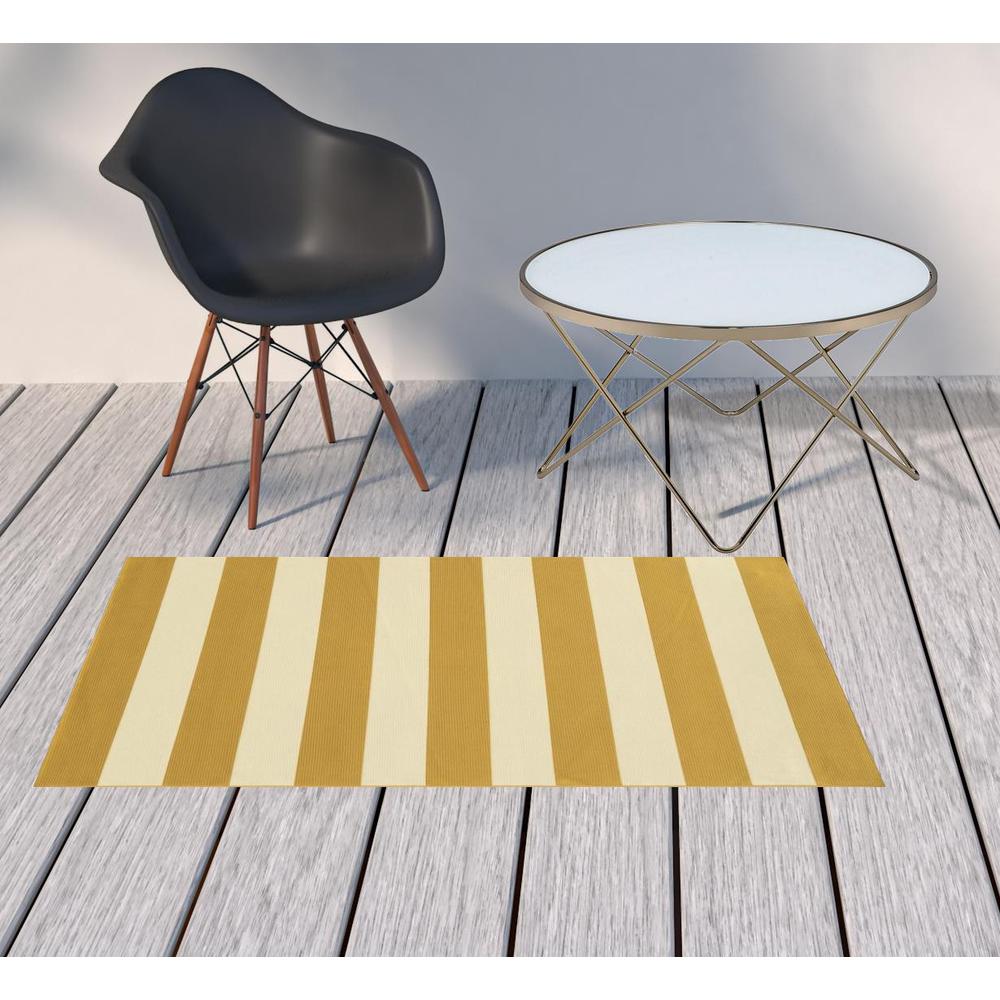 2' X 4' Gold and Ivory Geometric Stain Resistant Indoor Outdoor Area Rug. Picture 2