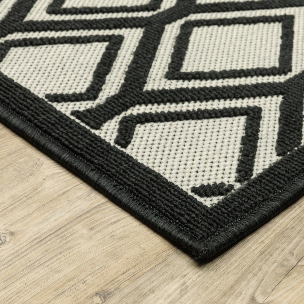 2' X 7' Beige and Black Geometric Stain Resistant Indoor Outdoor Area Rug. Picture 4