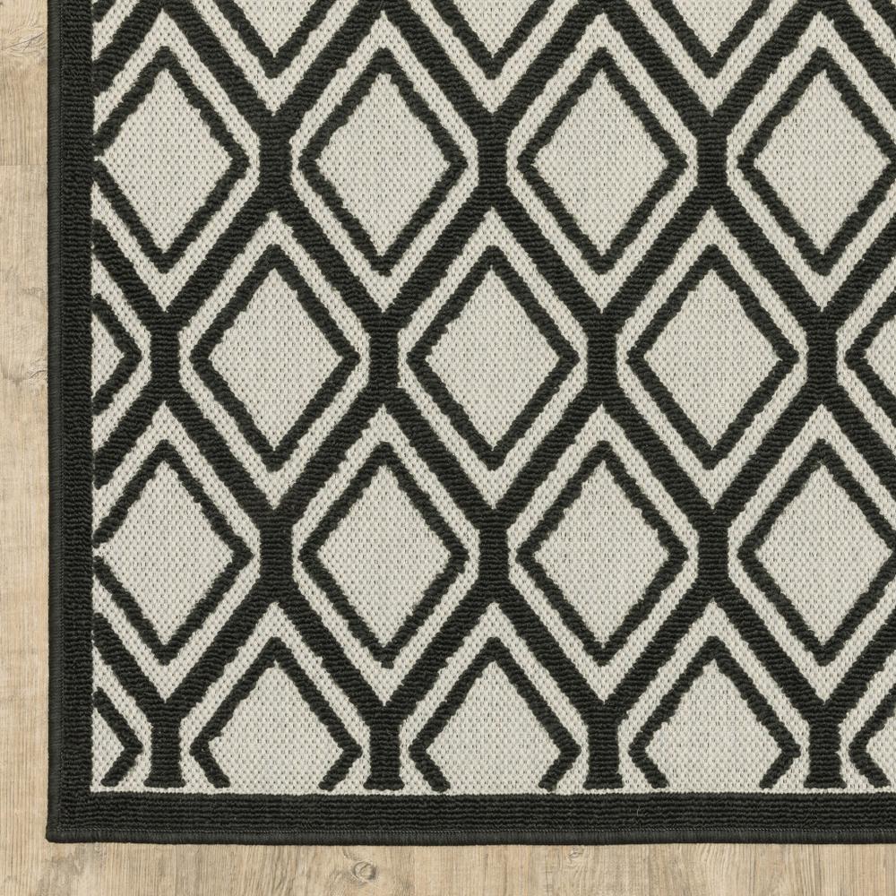 2' X 7' Beige and Black Geometric Stain Resistant Indoor Outdoor Area Rug. Picture 3