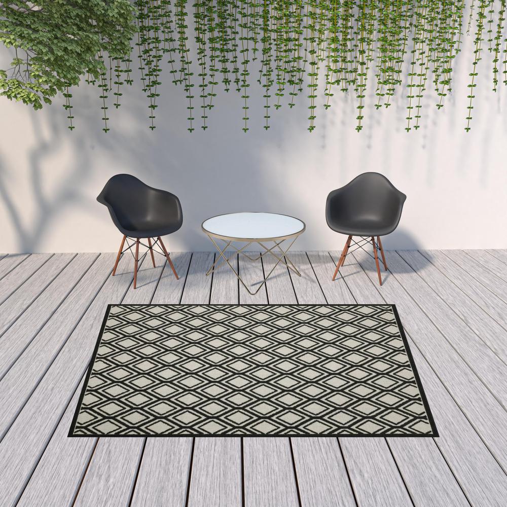 7' x 9' Beige and Black Geometric Stain Resistant Indoor Outdoor Area Rug. Picture 2