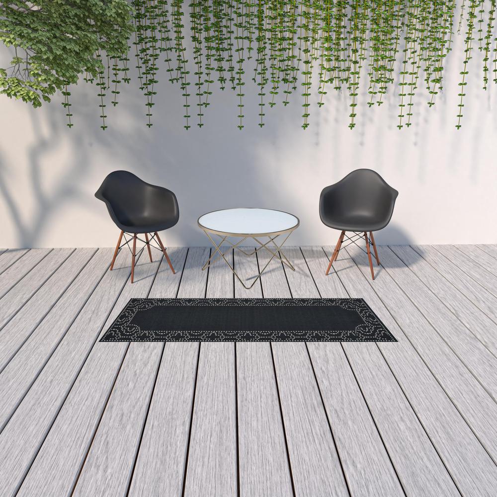 2' X 8' Black and Ivory Stain Resistant Indoor Outdoor Area Rug. Picture 2