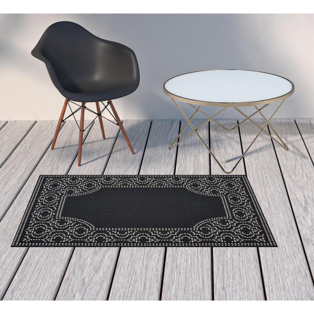 2' X 4' Black and Ivory Stain Resistant Indoor Outdoor Area Rug. Picture 2