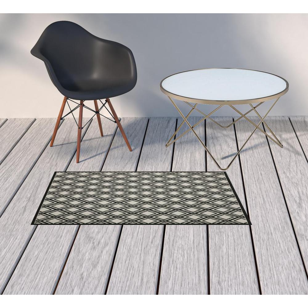 2' X 4' Beige and Black Geometric Stain Resistant Indoor Outdoor Area Rug. Picture 2