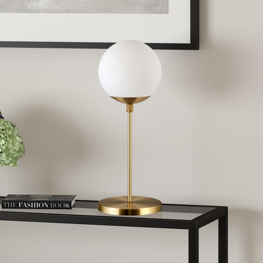 Theia 21" Tall Globe & Stem Table Lamp with Glass Shade in Brass/Clear. Picture 2